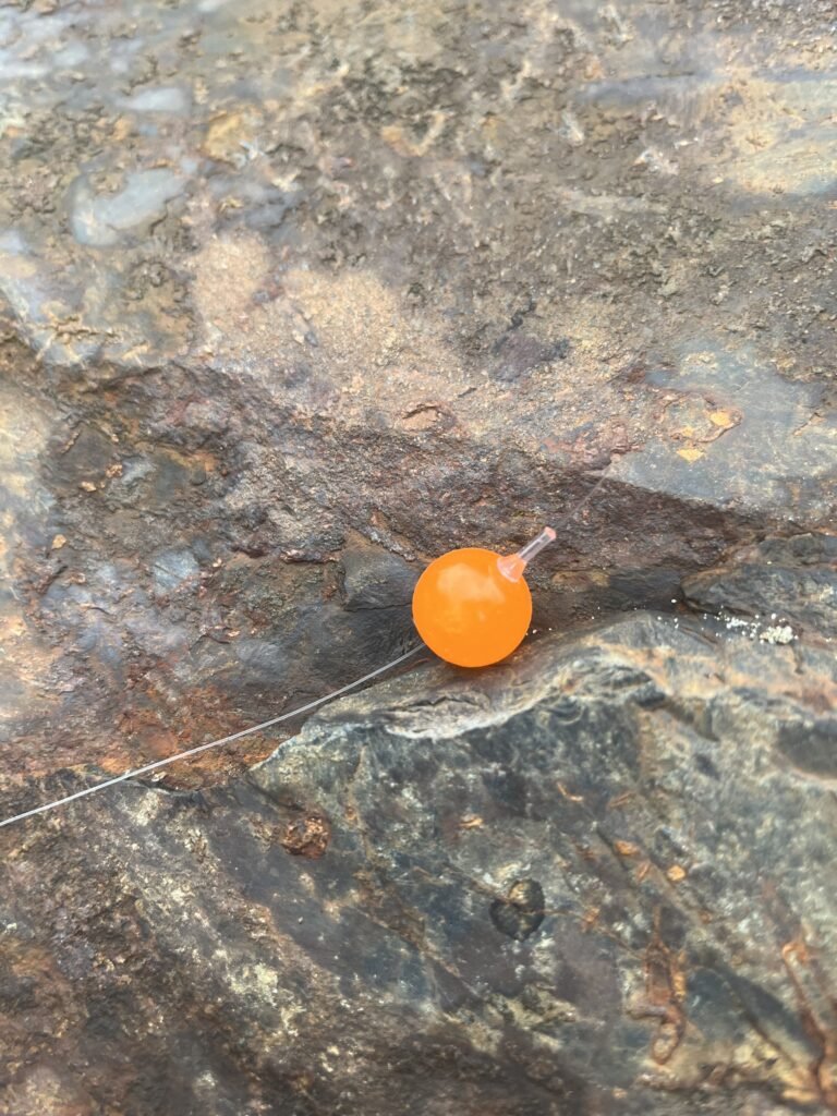 East Coast Salmon Rigging Flo Orange soft bead on rock