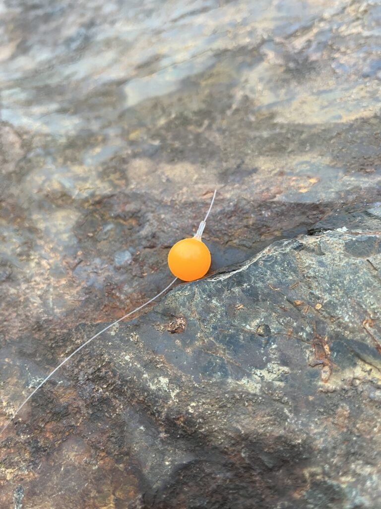 Orange Pearl Soft Bead on rock