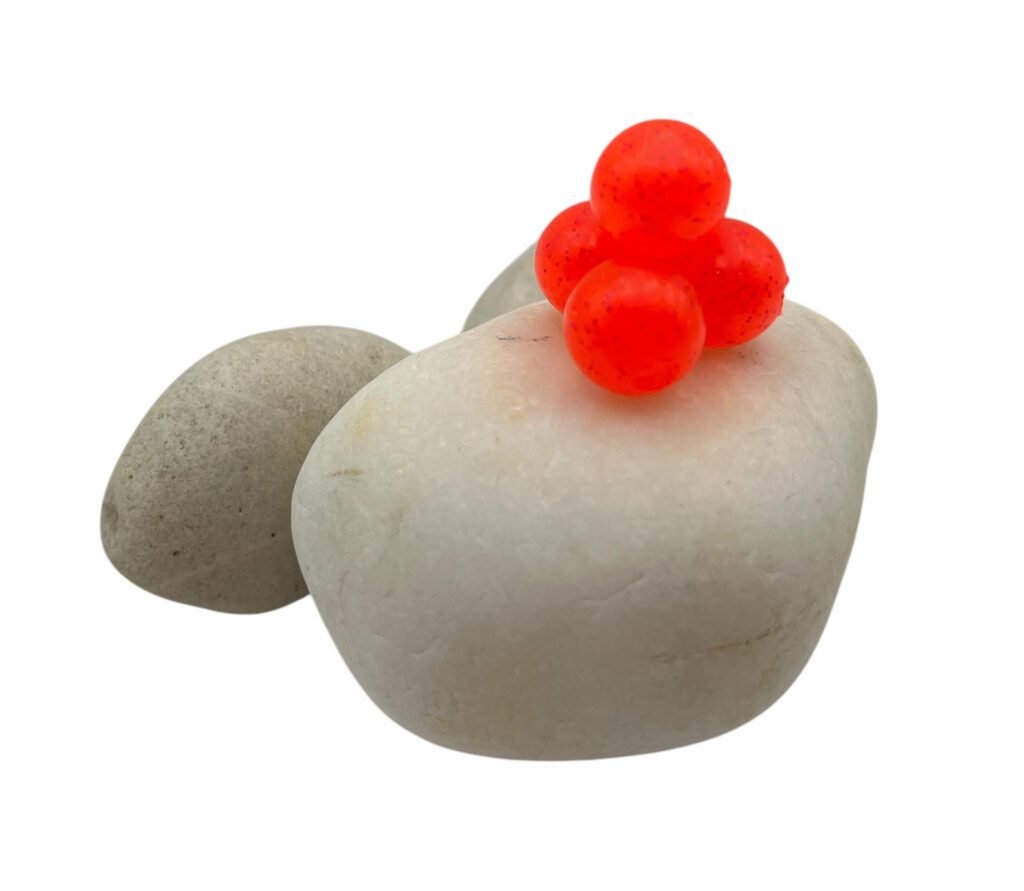 Watermelon Soft Beads on white rock