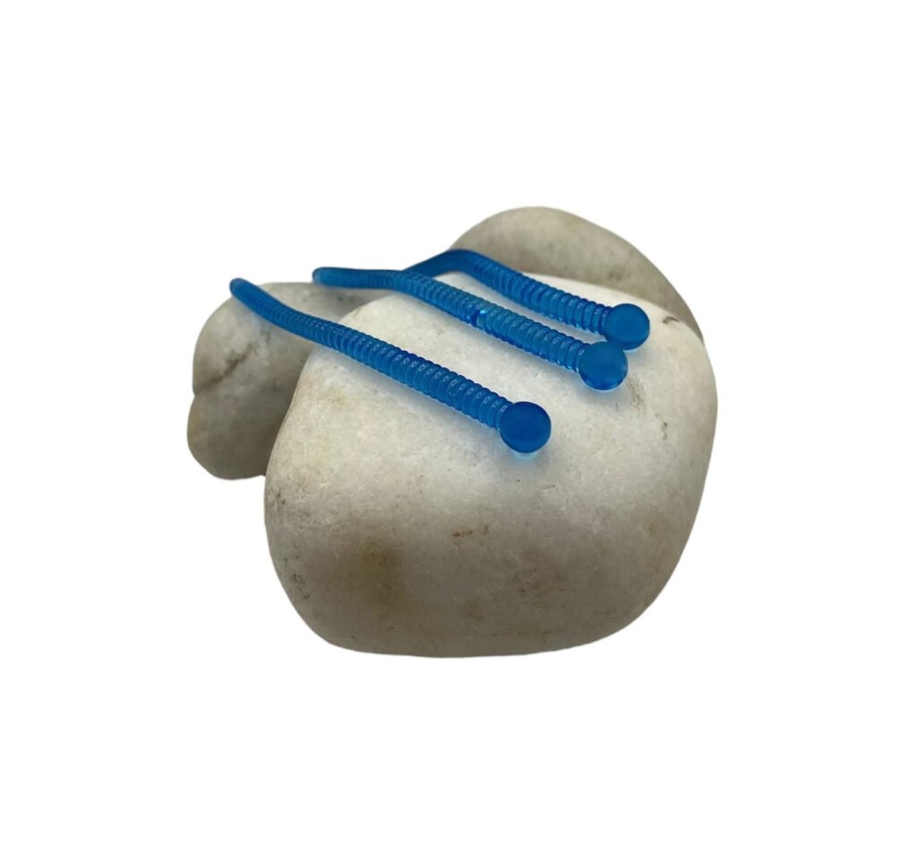 Wacky Rig fishing technique Bright Blue Soft Worms on rock